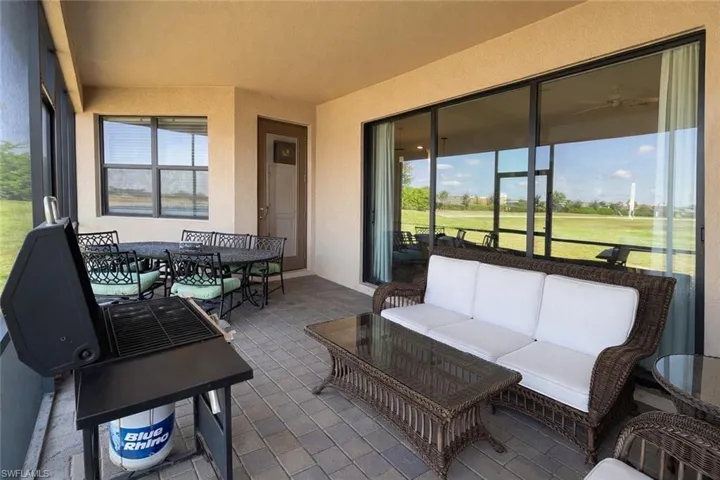 Sunroom / solarium featuring an outdoor living / dining area and view of golf course