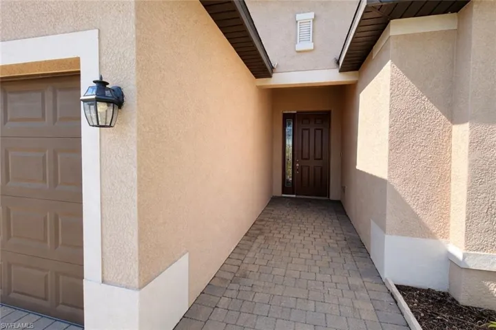 View of exterior entry with stucco siding