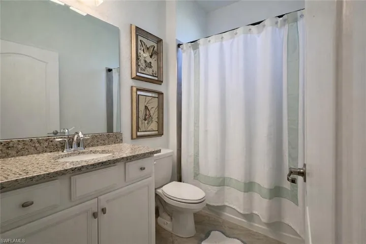 Full bath with vanity and shower / bath combo with shower curtain
