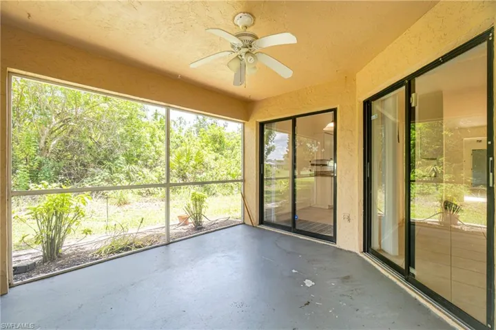 Unfurnished sunroom featuring ceiling fan