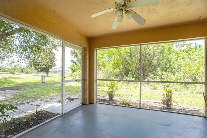 Unfurnished sunroom with a ceiling fan