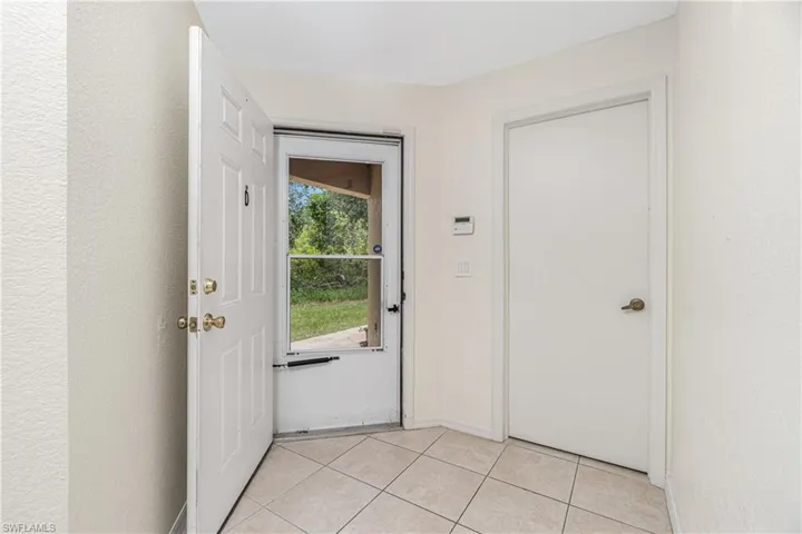 Doorway to outside with light tile patterned flooring