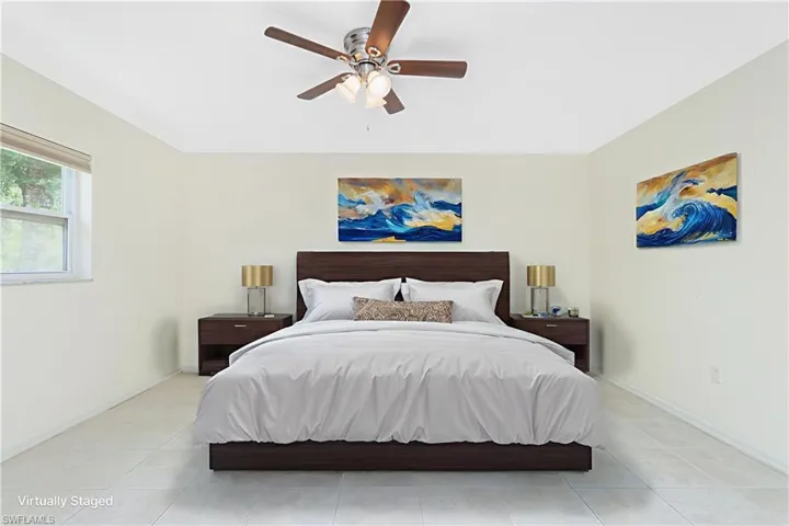 Bedroom featuring light tile patterned floors and a ceiling fan