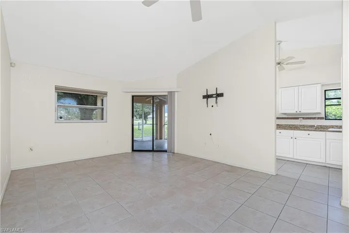 Unfurnished room with a ceiling fan, light tile patterned flooring, and high vaulted ceiling