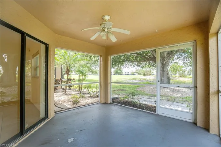 Unfurnished sunroom featuring ceiling fan