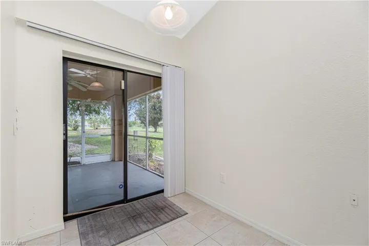Entryway featuring light tile patterned floors, vaulted ceiling, and a ceiling fan