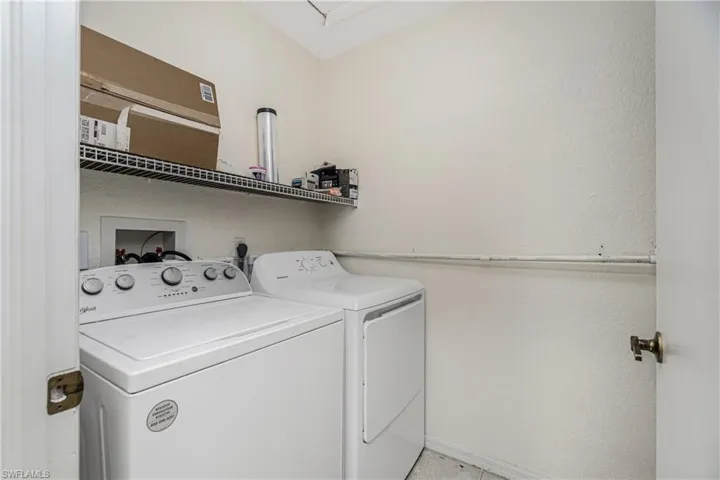 Washroom featuring washing machine and clothes dryer