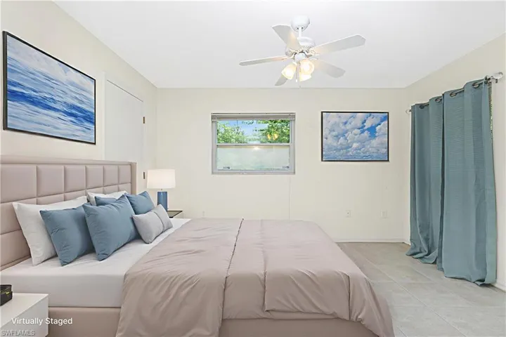 Bedroom featuring light tile patterned floors and a ceiling fan