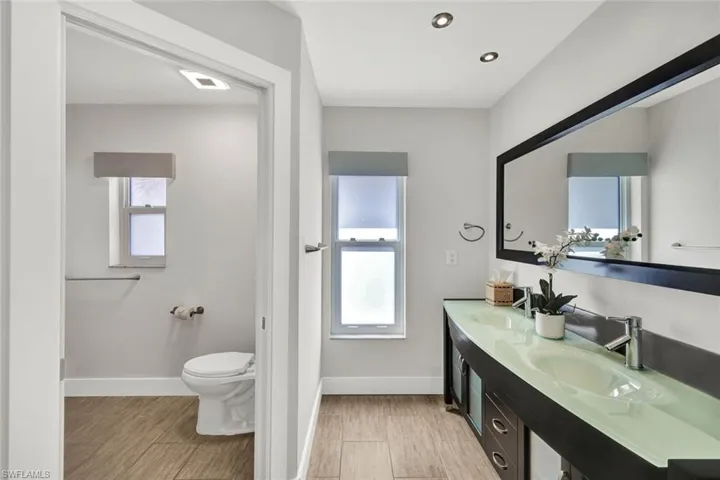 Dual sinks with separate sower /commode room also opens to pool