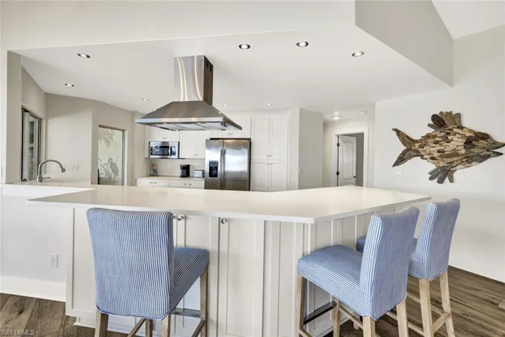 Hanging out at the modern island with front and rear access to kitchen cabinetry