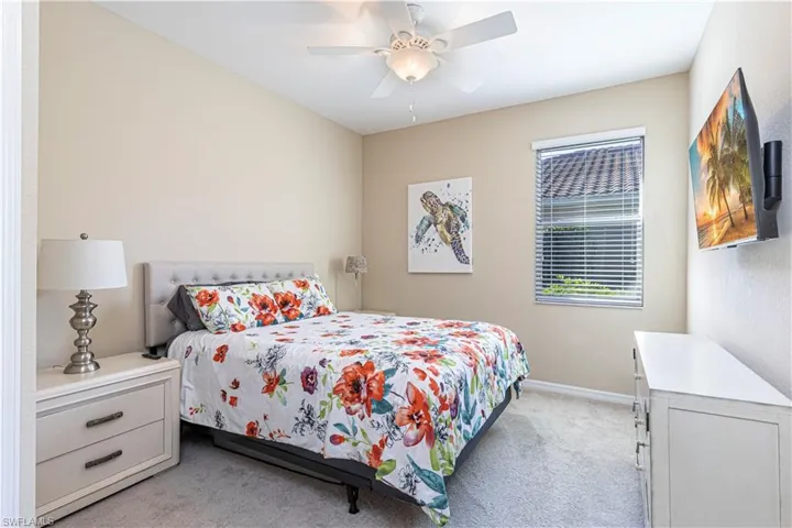 Bedroom featuring ceiling fan and light colored carpet