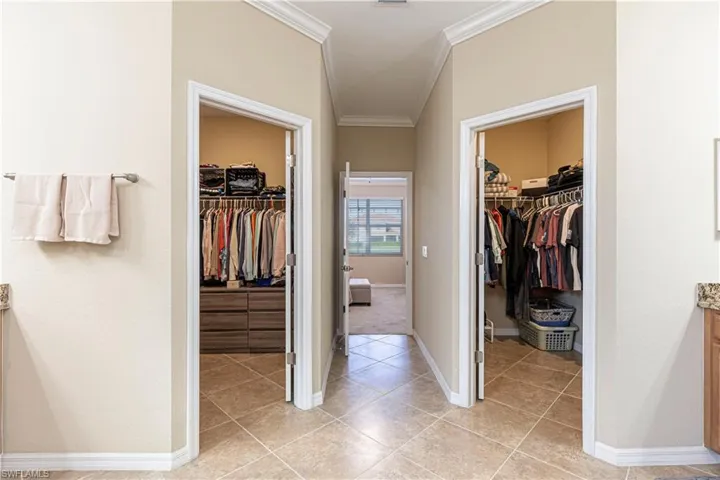 Bathroom featuring ornamental molding and tile patterned floors