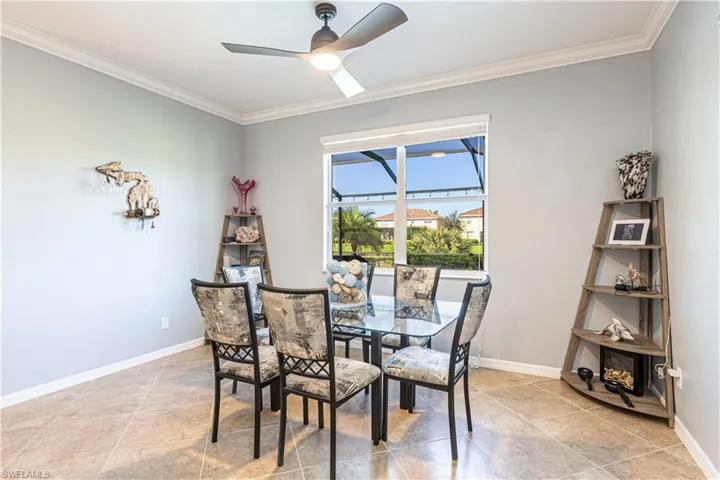 Dining space with ceiling fan and ornamental molding