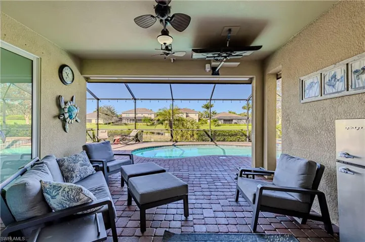View of patio with a lanai, outdoor lounge area, and ceiling fan