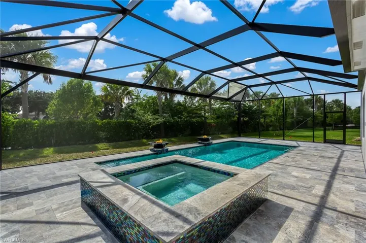 Widened Lanai, Travertine flooring, water/fire bowls, & frameless screened cage.