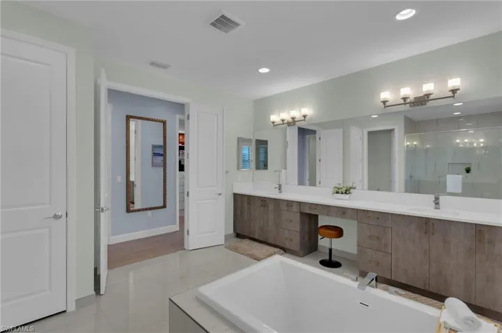 Quartz Counters, dual sinks, separate garden tub & frameless tile shower