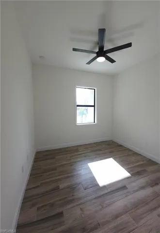 Bedroom 3, Wood-finish plank flooring, single window, white walls, and a ceiling fan with integrated lighting