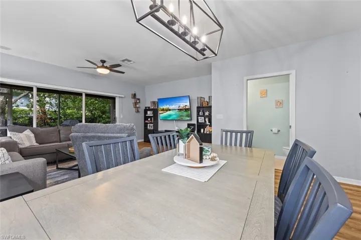 Dining area featuring wood finished floors and a ceiling fan