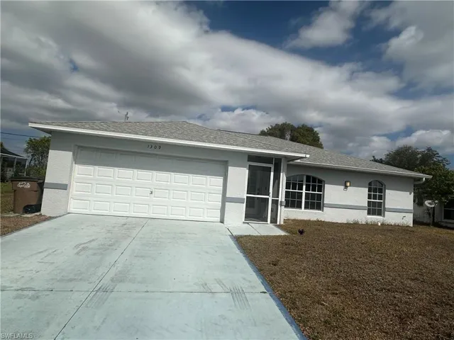 Ranch-style house with a garage, stucco siding, concrete driveway, and a shingled roof