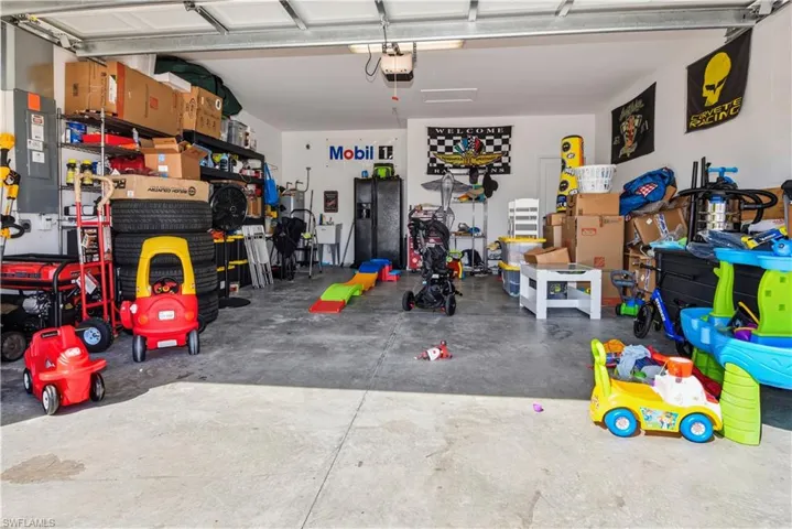 Two-car garage with concrete flooring and overhead garage door