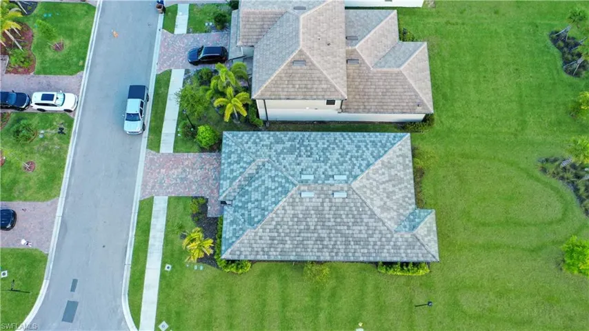 Residential property with a multi-toned shingle roof and skylights