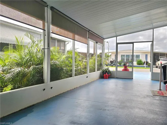 Unfurnished sunroom with finished concrete flooring