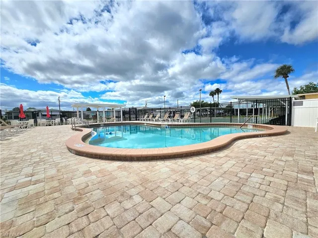 Community pool with a patio