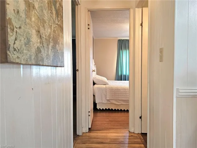 Hall featuring wood finished floors and wood walls