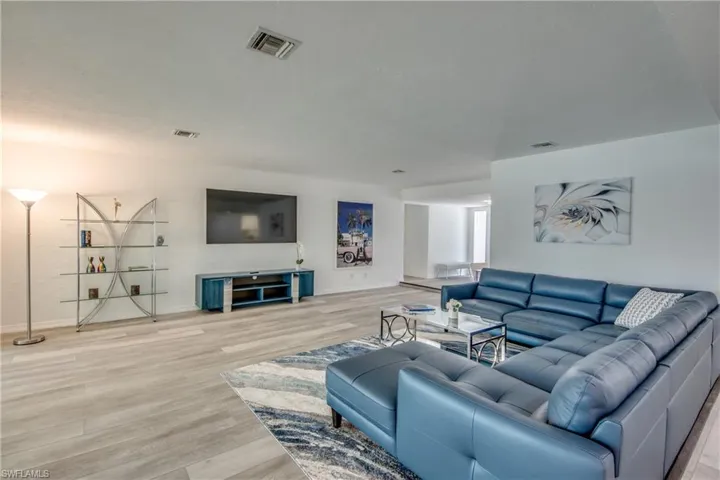 Living area featuring light wood-style floors and baseboards