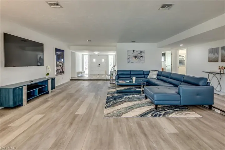 Living area featuring light wood-style floors and baseboards
