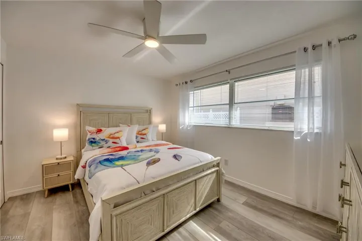 Bedroom featuring light wood-style flooring, baseboards, and ceiling fan