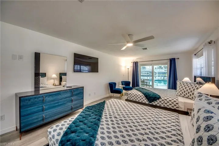 Bedroom with light wood finished floors, baseboards, and ceiling fan