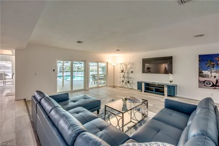 Living area featuring light wood finished floors, healthy amount of natural light, and baseboards
