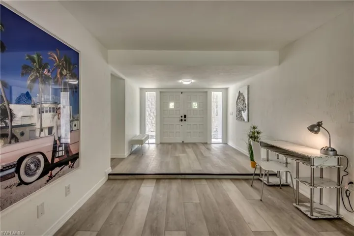 Entryway featuring wood finished floors and baseboards