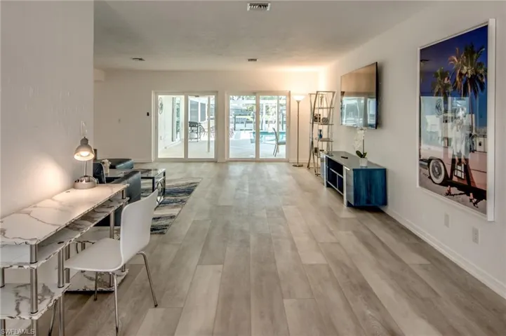 Living area featuring light wood-type flooring and baseboards