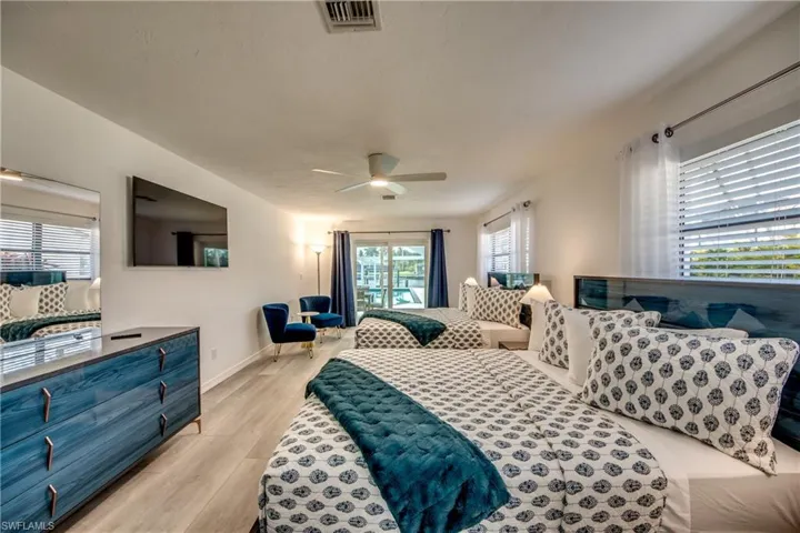 Bedroom with light wood finished floors, baseboards, and a ceiling fan