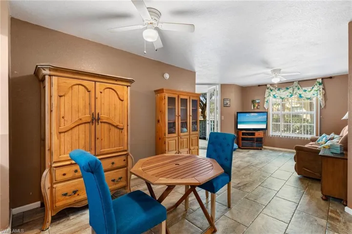 Dining space with a textured ceiling and ceiling fan