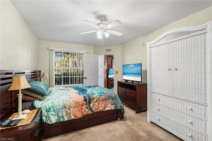 Bedroom with light colored carpet and ceiling fan