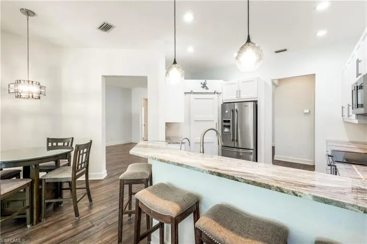 EAT IN KITCHEN AND BREAKFAST BAR FOR CONVENIENT FAMILY MEALS