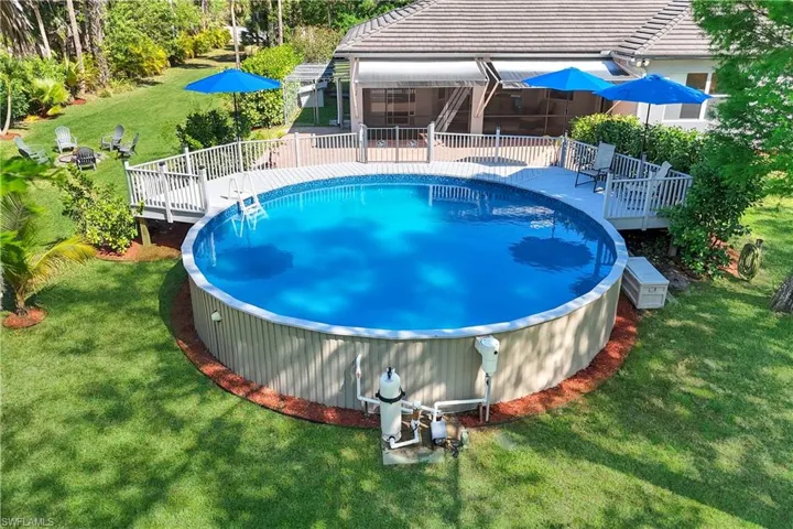 POOL HAS NEW PUMP AND FILTER, NEWLY PAINTED DECK AND SHARP BLUE UMBRELLAS