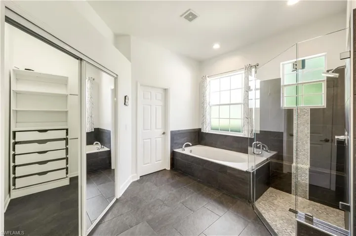 MAIN BATH HAS HUGE WALK IN CLOSET, SOAKING TUB, WALK IN SHOWER, TILE FLOOR