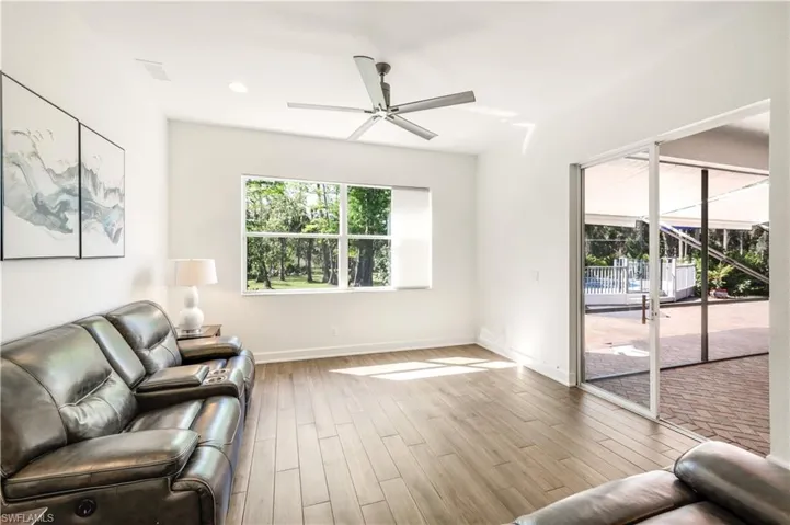 FAMILY ROOM OPENS TO BRICK PAVER SCREENED PORCH
