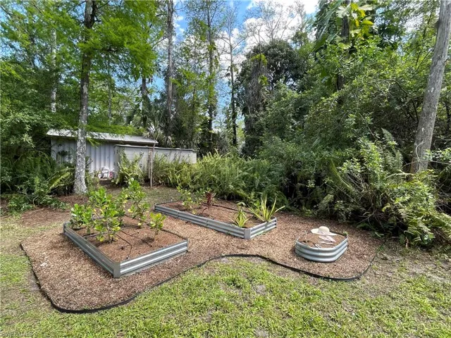 GARDEN BEDS HAVE BUILT IN IRRIGATION AND NEARBY WATER SPIGOT