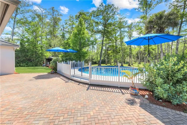 BRICK PAVER DECK, SCREENED INDOOR PORCH, OPEN OUTDOOR PORCH HAS RETRACTABLE AWNINGS
