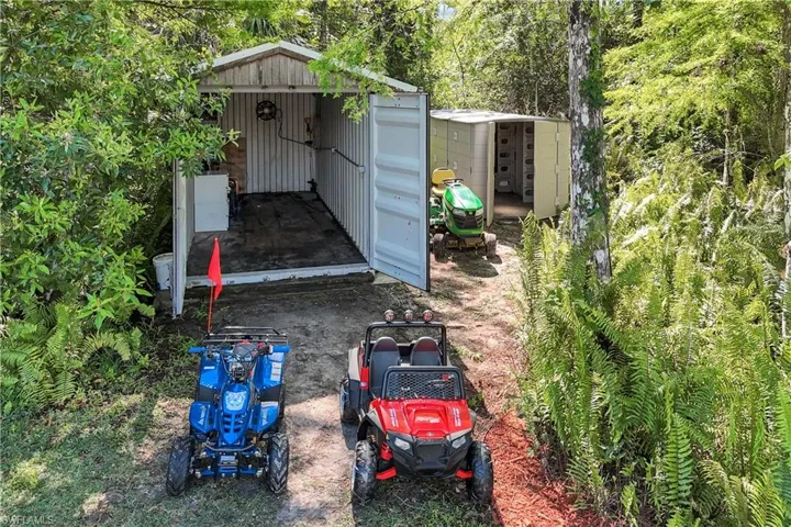 SHED FOR ADULT BLACK 4 WHEELER AND KIDS BLUE 4 WHEELER, BOTH INCLUDED