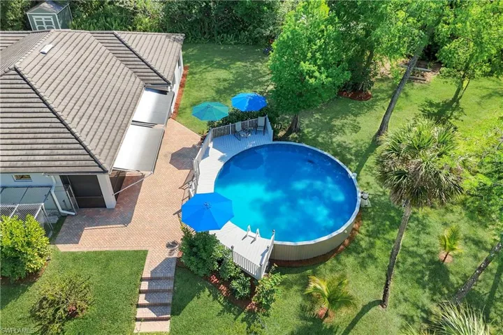 DOG KENNEL ON THE LEFT, ATTACHED TO SCREENED PORCH, ACCESSIBLE FROM MAIN BEDROOM, THROUGH DOGGIE DOOR, AWNINGS OPENED POOLSIDE, MEDALLION POOL, BRICK PAVER DECK
