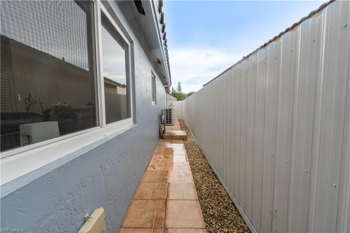View of property exterior with a fenced backyard and stucco siding