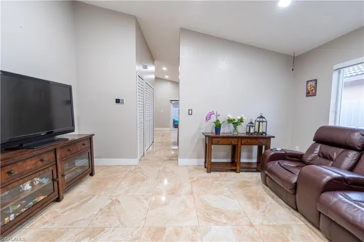 Living room featuring light marble finish flooring and recessed lighting