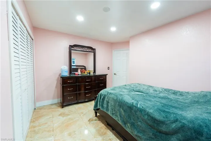 Bedroom with recessed lighting and light marble finish flooring