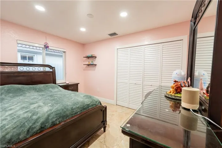 Bedroom with recessed lighting and a closet